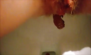 Shaved girl shitting in toilet