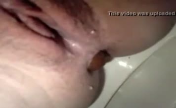 Shaved babe pooping in close up